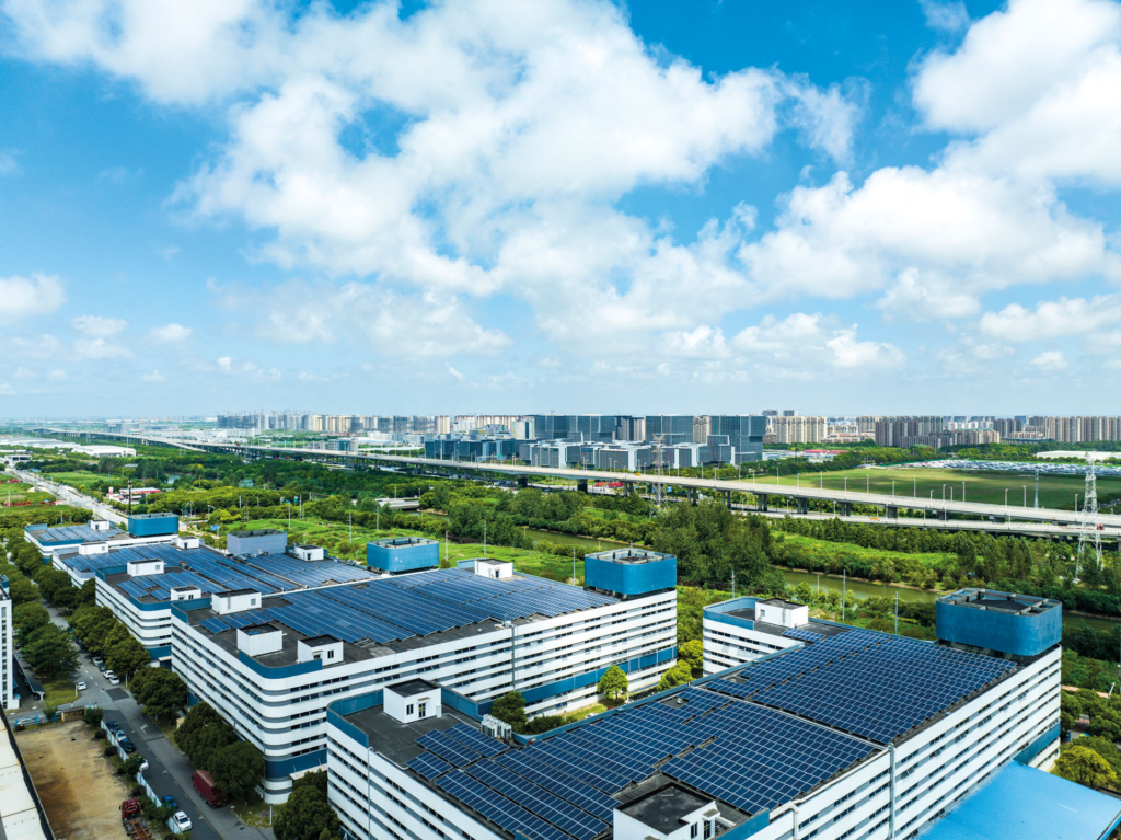 Aerial view of solar panels installed on factory rooftop,Blue shiny solar photo voltaic panels system product.